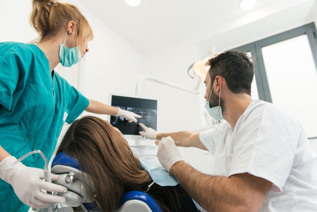 Dentist and assistant during dental surgery