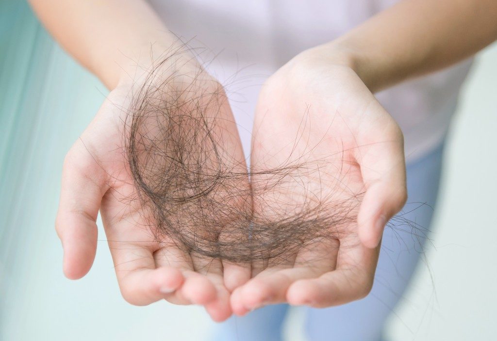 person holding a hairball