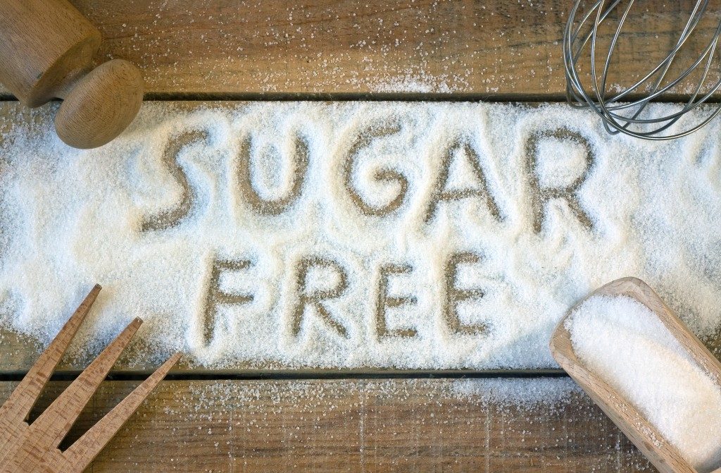 sugar free written through sugar on wooden table