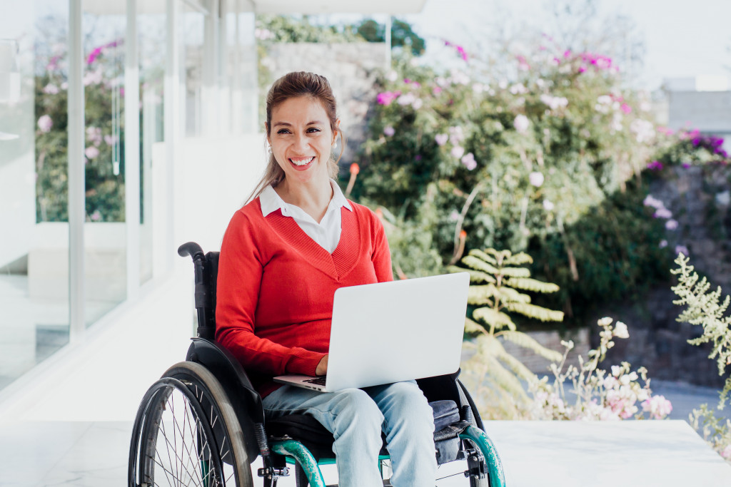 A woman in a wheelchair working on a laptop