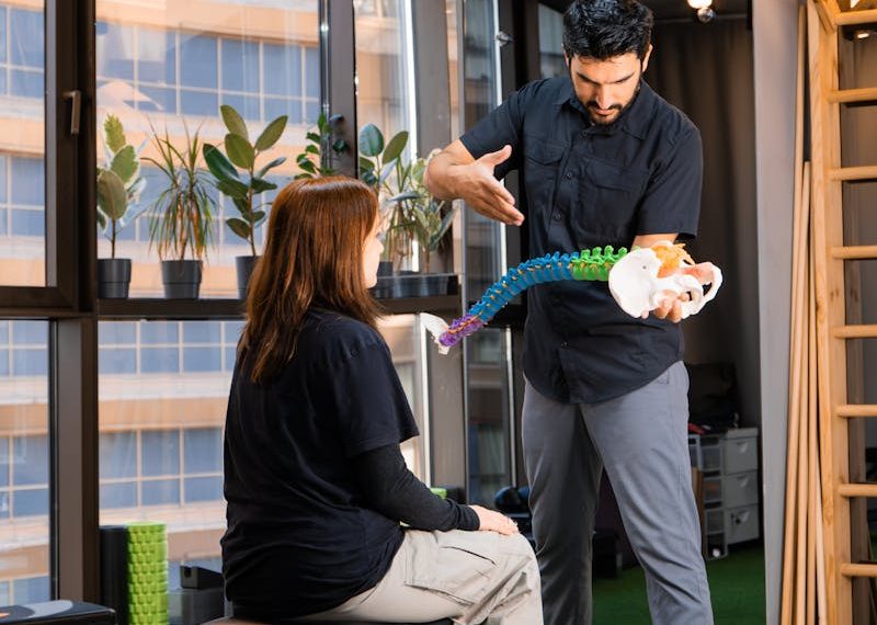 a chiropractor explaining something to a patient