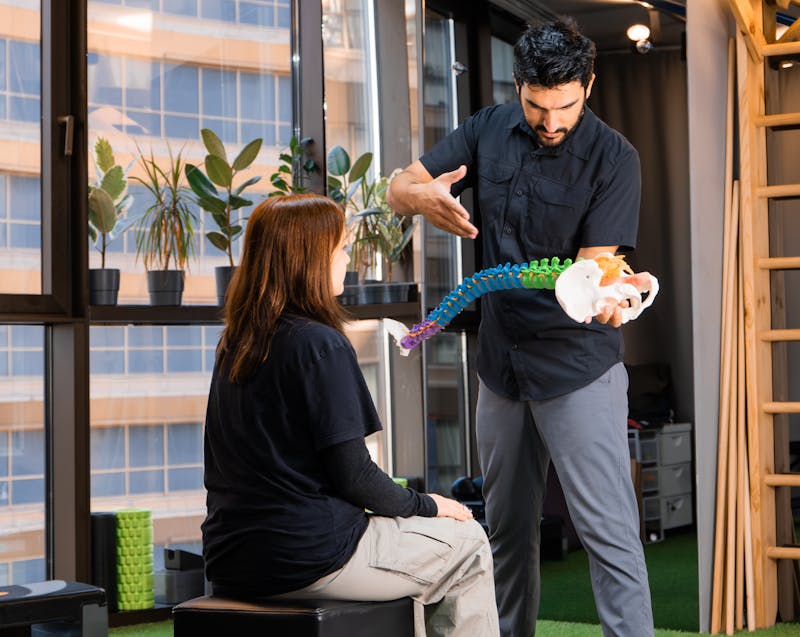 a chiropractor explaining something to a patient